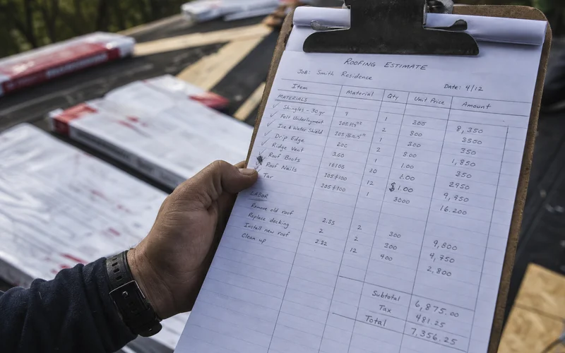 Close-up of a roofing contractor's written estimate showing itemized materials and labor lines