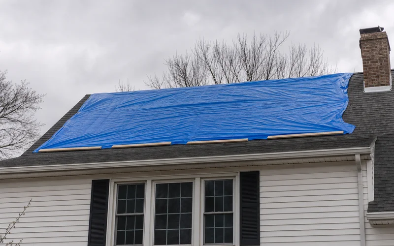 Properly tarped roof section with weighted edge securing technique