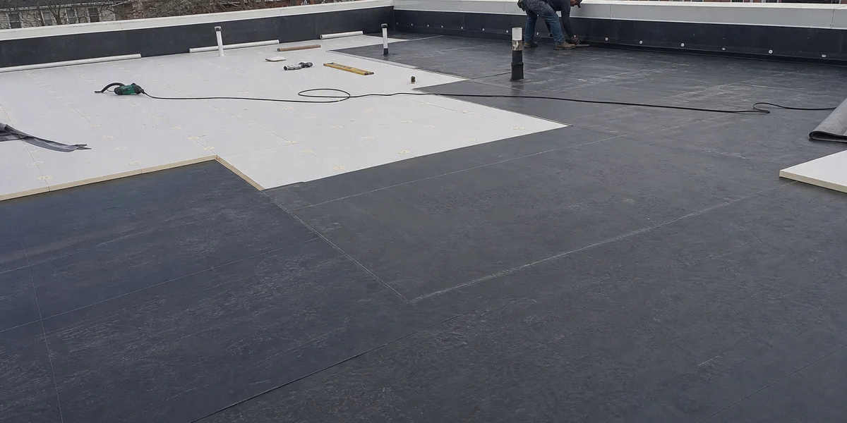 Commercial EPDM rubber roof install with ISO board insulation and termination bar at parapet wall in New Britain Connecticut